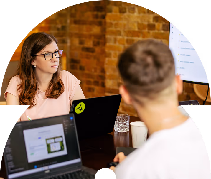 Two Team 4 members and computers showing website designs