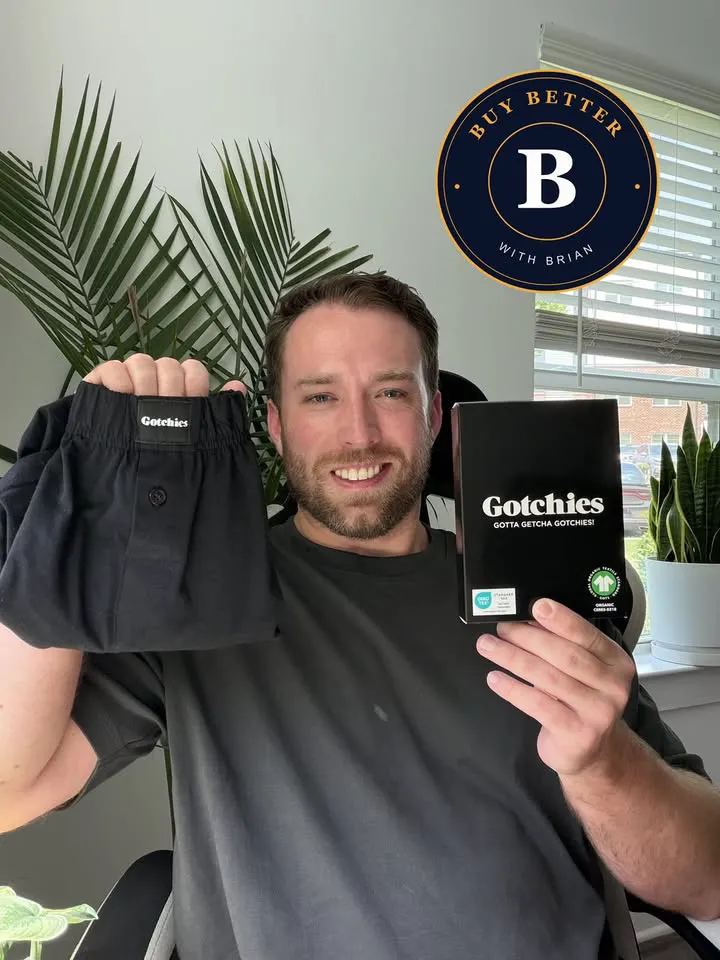 man holding up Gotchies boxers and packaging