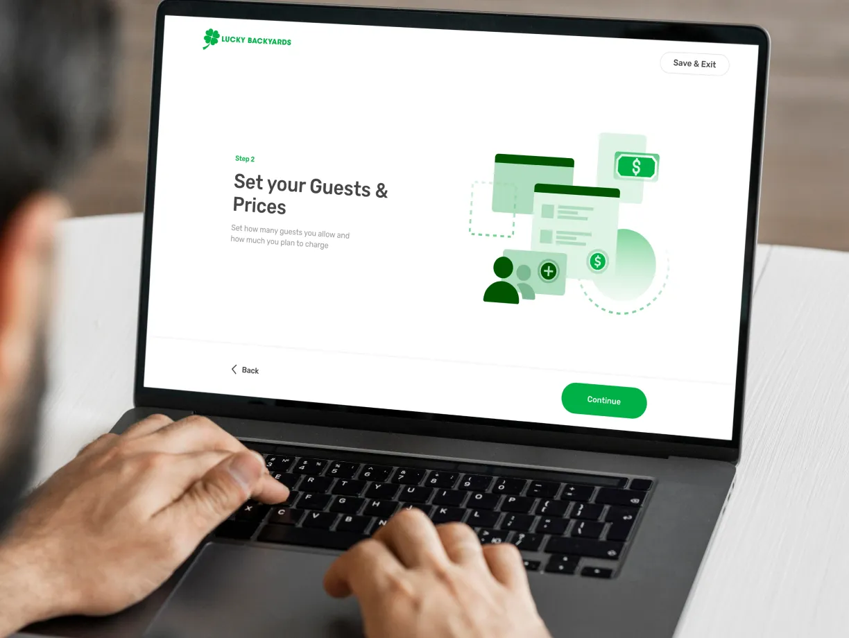 A man sitting at a table using a laptop computer.