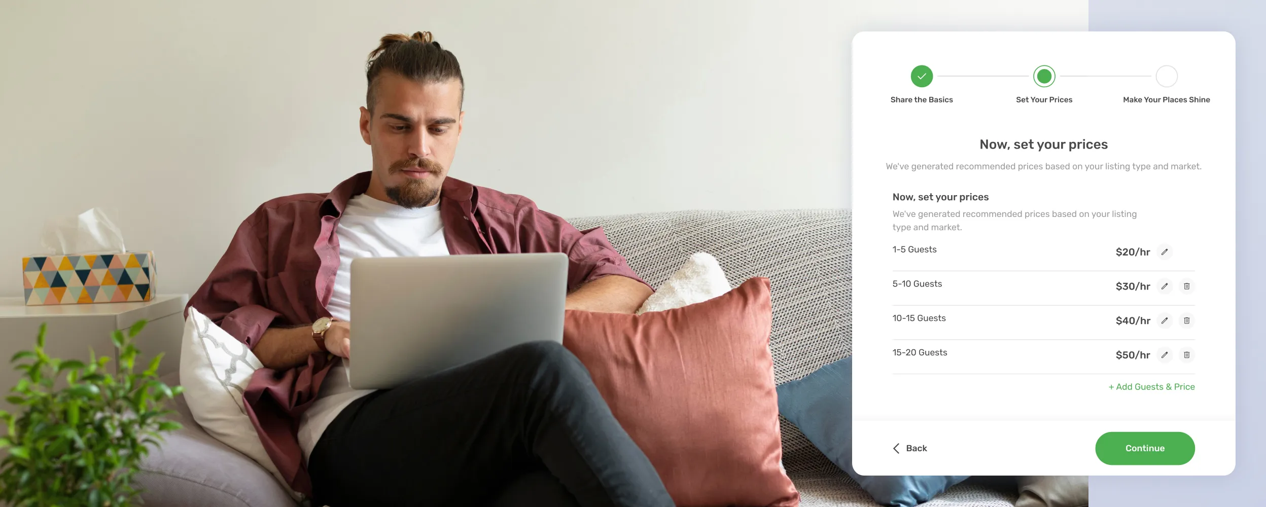 A man sitting on a couch using a laptop.