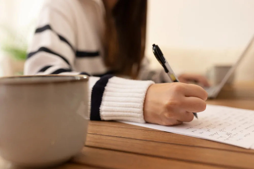 Student studying with pen and paper