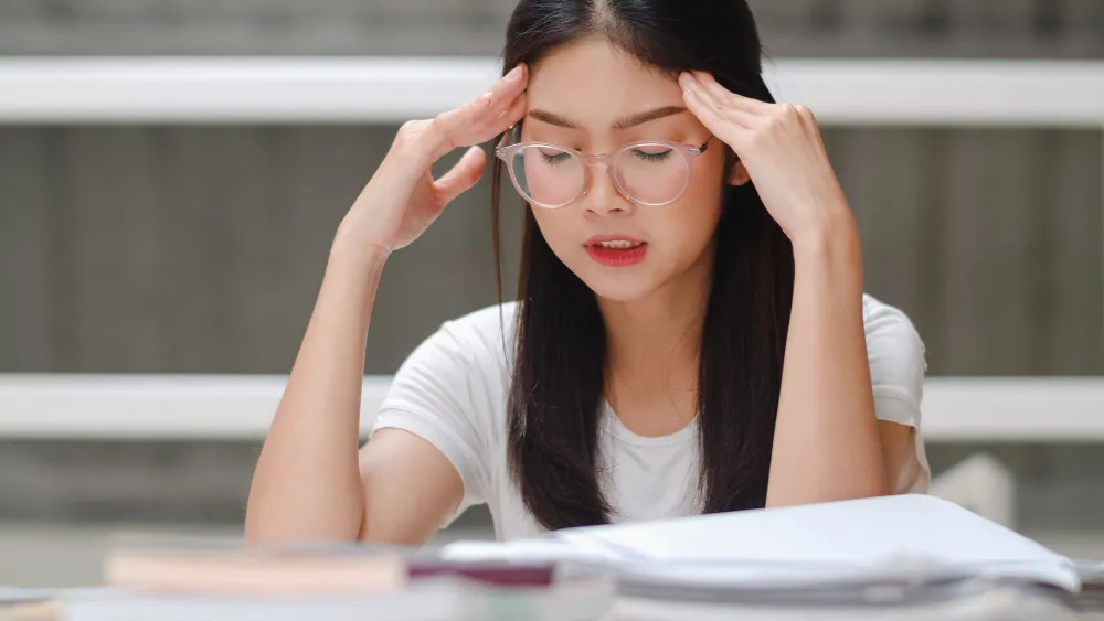 Student studying and looking stressed