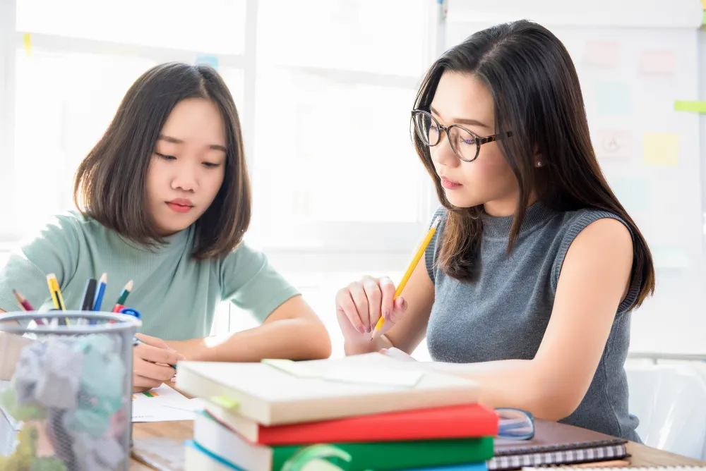 Tutor helping student study