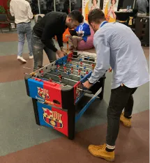 BrainDonors team members playing an arcade game together.