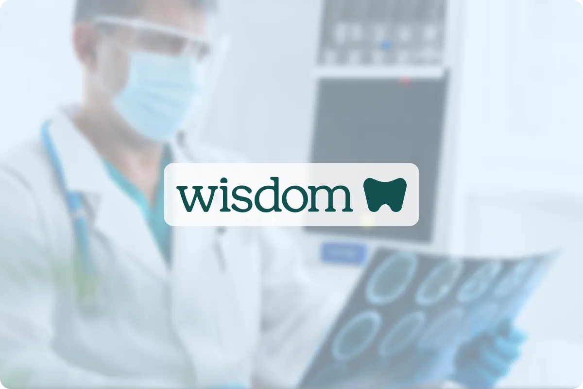 Wisdom logo on an opaque background with a doctor in a doctors office