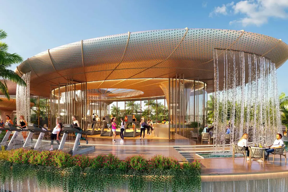 Outdoor fitness area with people exercising on treadmills under a large circular canopy with cascading water waterfalls and seating area.