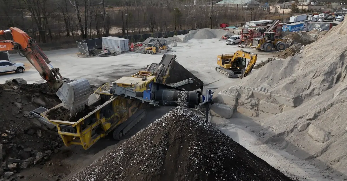 Structural fill dirt processed and sorted by machinery at an industrial materials yard.