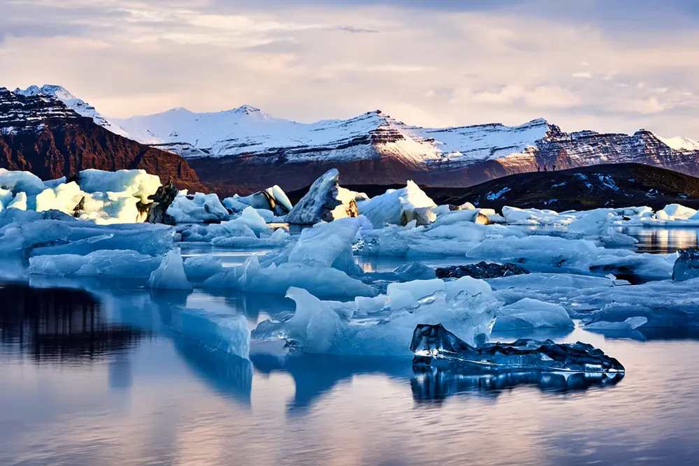 Jökulsárlón Glacier Lagoon with floating icebergs at golden hour, southeast Iceland