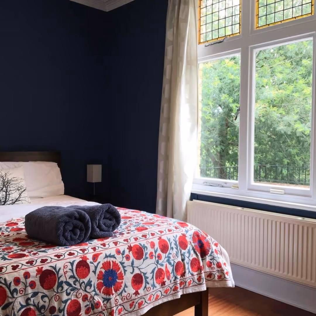 dark blue bedroom with stained glass windows 