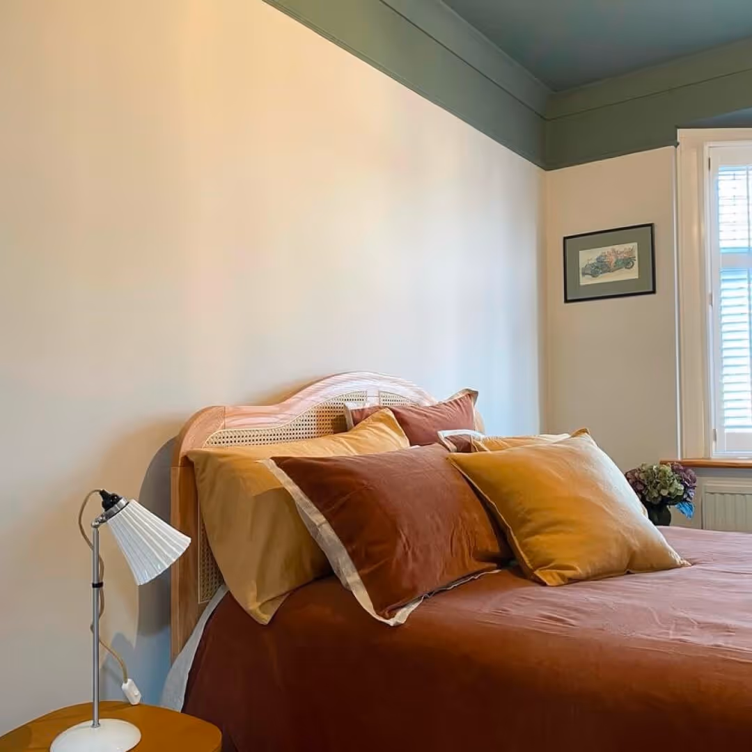 bedroom painted with a dark green ceiling and picture rail installed