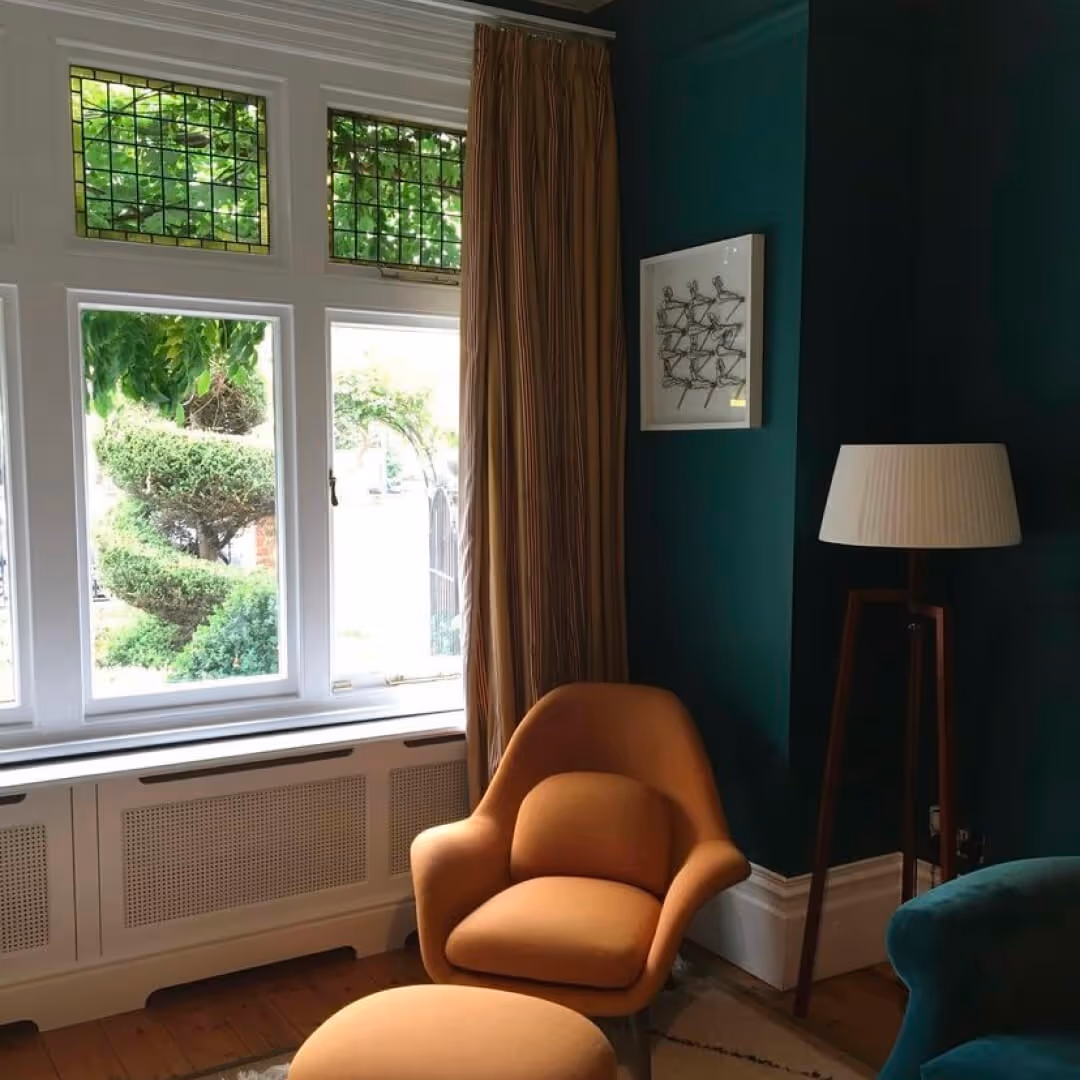 A teal lounge with an orange seat
