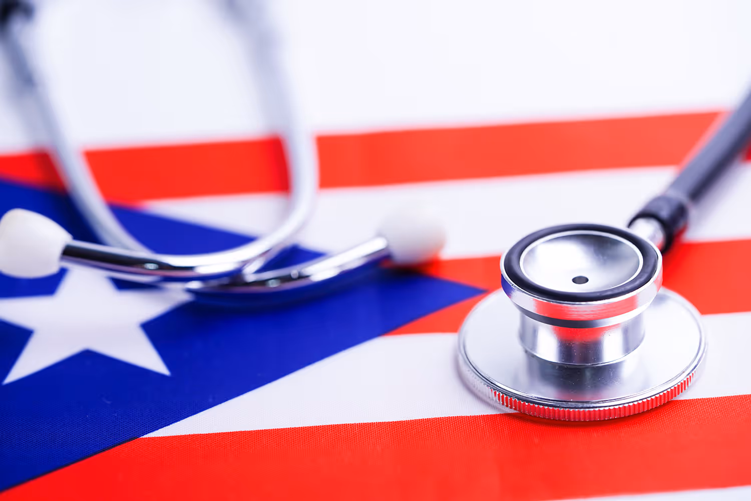Close-up of a stethoscope lying on the Puerto Rican flag.