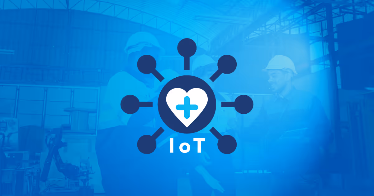 IoT icon with a heart and medical cross symbol overlaying a background of workers wearing helmets in an industrial setting.