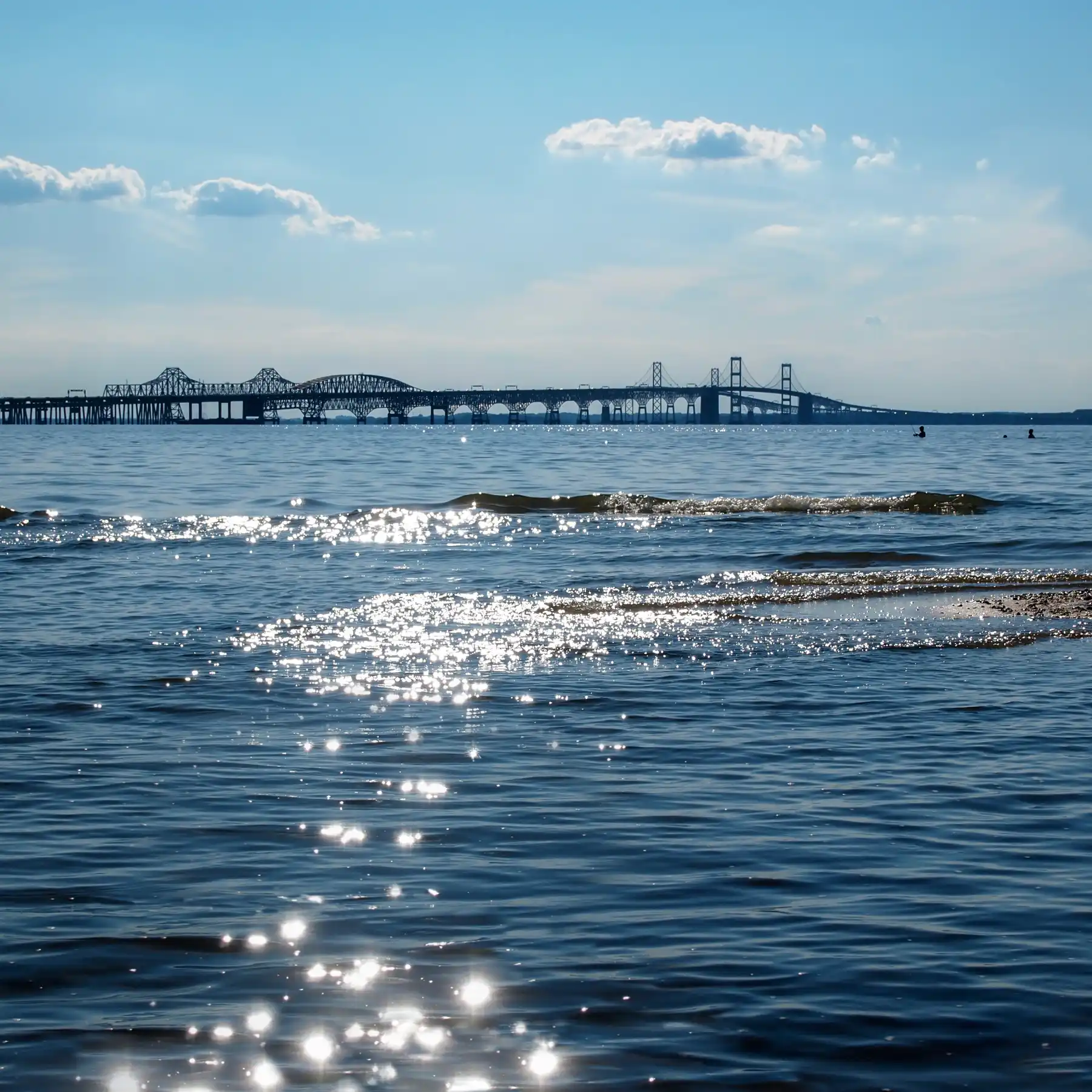 Sun glistening on the water in Chesapeake Bay; bridge in the background