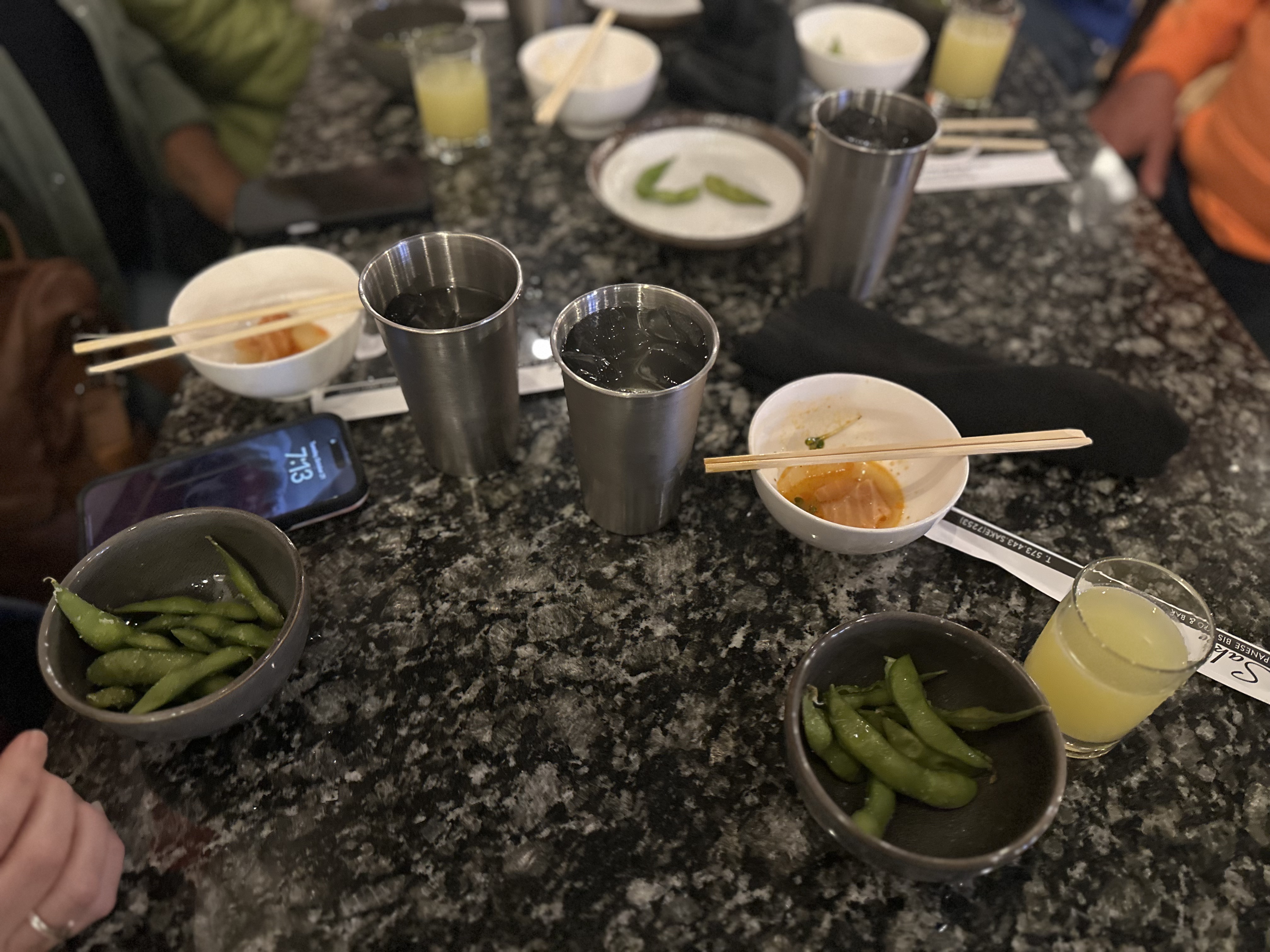 Freshly sliced bread served on a rustic wooden plate, paired with savory olive-stuffed ham and rich, aged cheese.