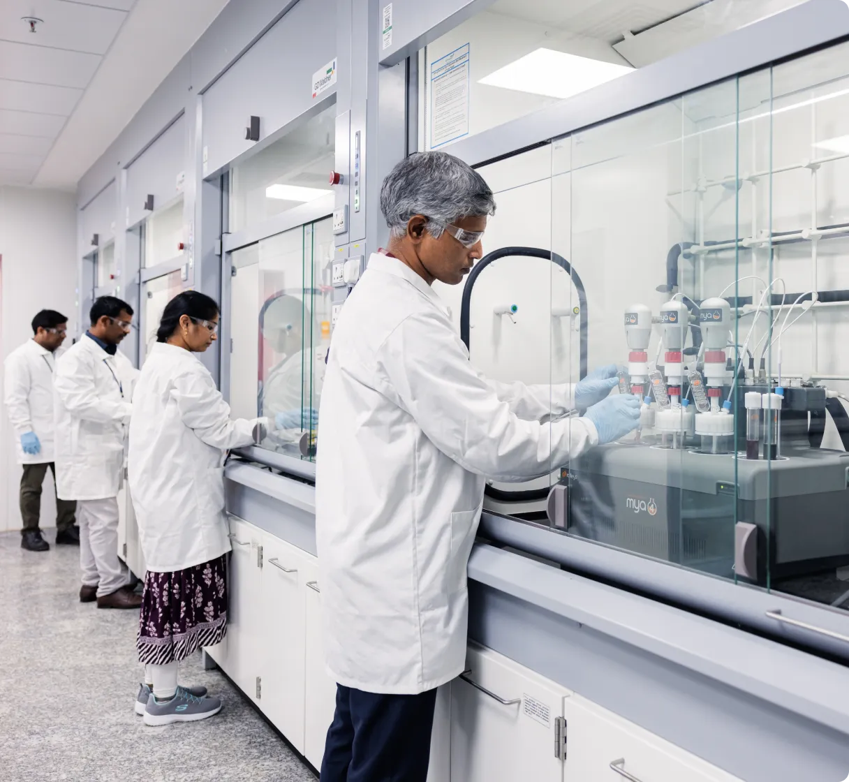 Team of scientists examining chemical reactions in a research lab