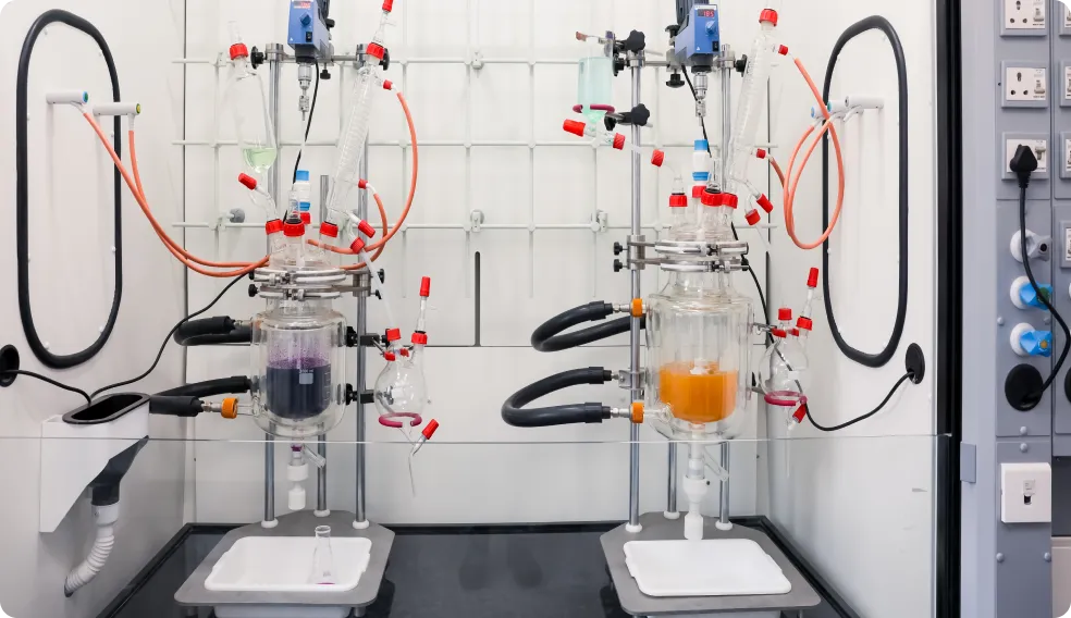A man in a lab coat is working on a machine.