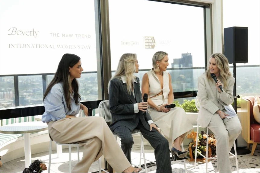 Four speakers with microphones at Beverly’s International Women’s Day panel event