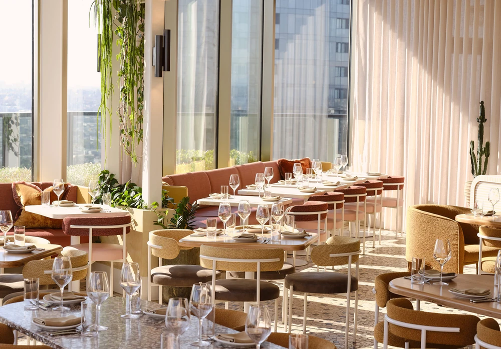 Sunlight across Beverly’s window-side tables, set for a gathering