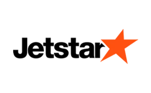 Logo Jetstar dengan bintang oranye di sebelah kanan tulisan.