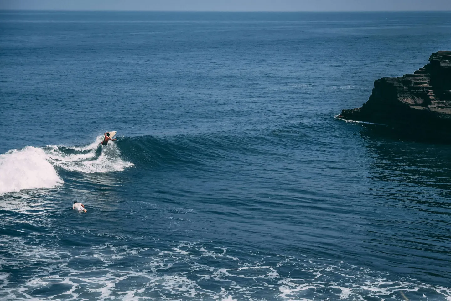 surfer on a wave in uluwatu bali