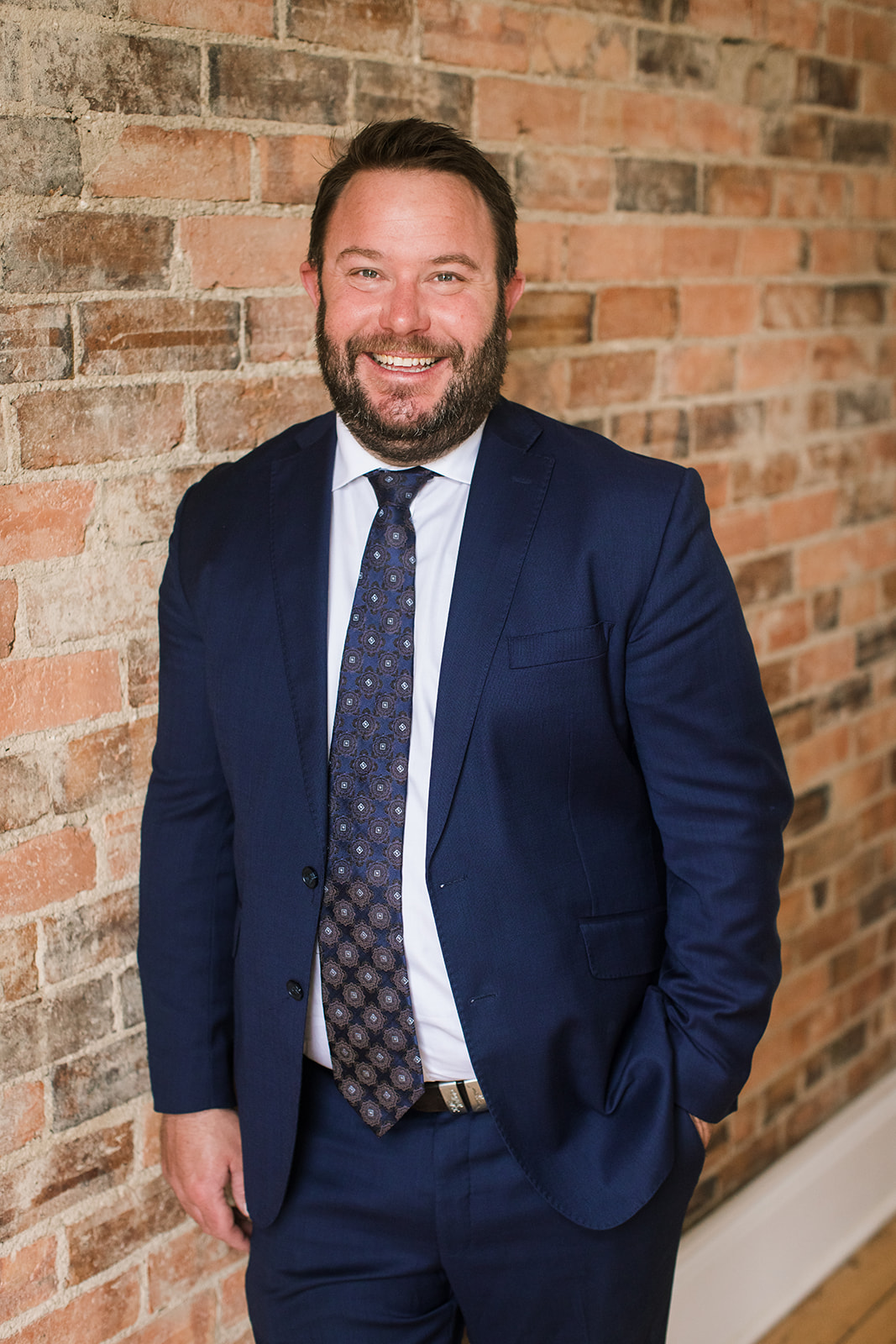 Pictured is Sean Linehan a lawyer at Wakefield Lawyers standing against a brick wall.