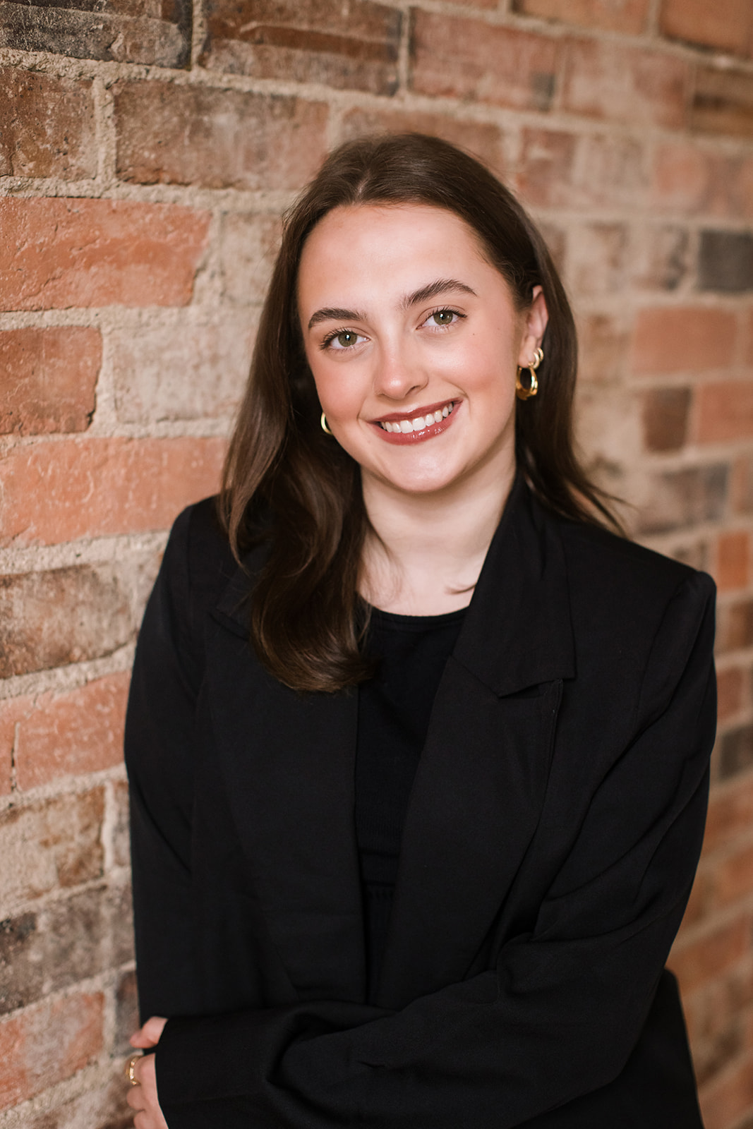Pictured standing next to a brick wall is Tyler Furlong who is a family law assistant at Wakefield Lawyers. 