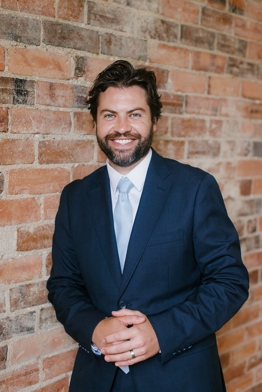 Pictured is Steve Novak a lawyer at Wakefield Lawyers he is standing in front of a brick wall.