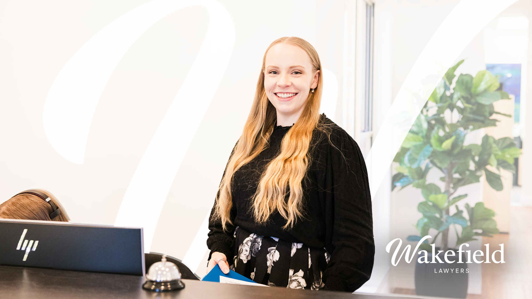 Pictured is Lauren Van Der Veen lawyer at Wakefield Lawyers standing at a desk.