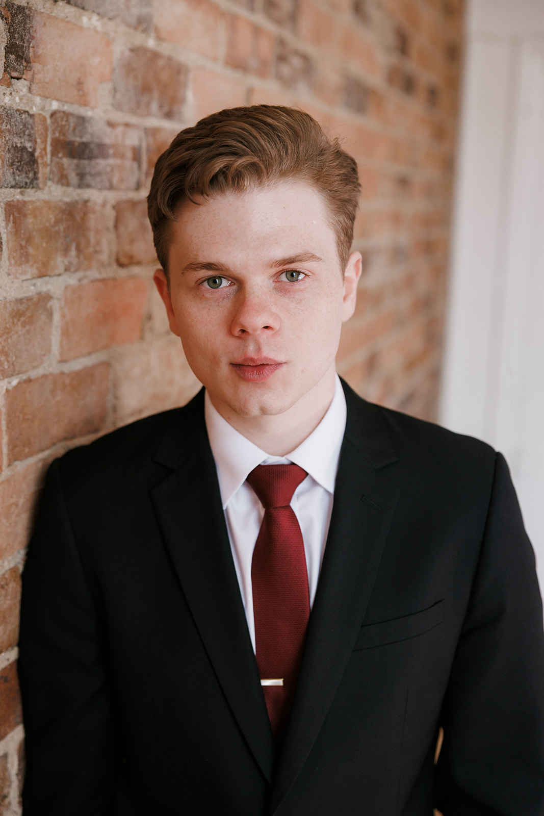 Andy Bailey from Wakefield Lawyers standing in front of a brick wall