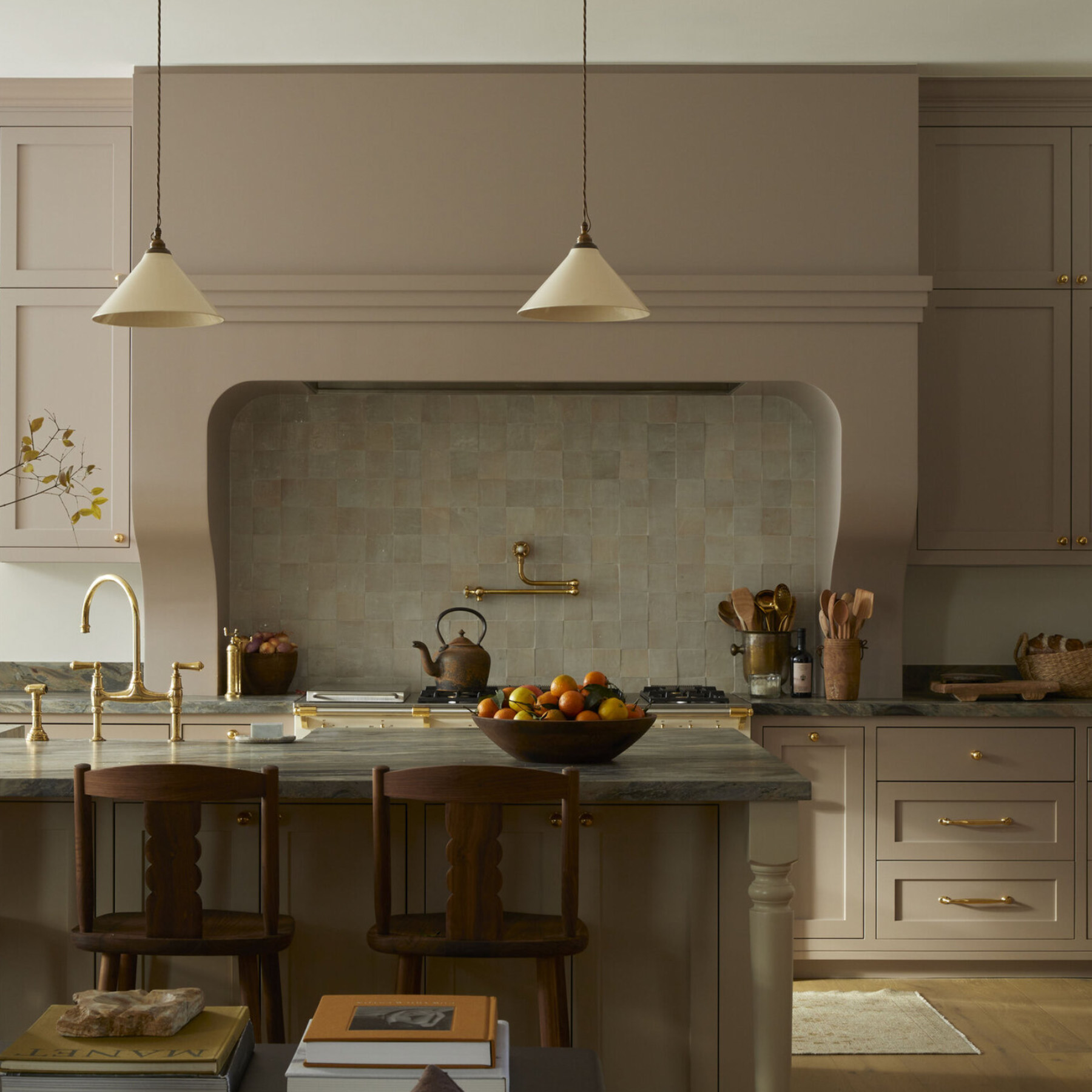 Warm taupe and greige kitchen cabinets showcasing warm undertones paired with natural wood and brass accents.