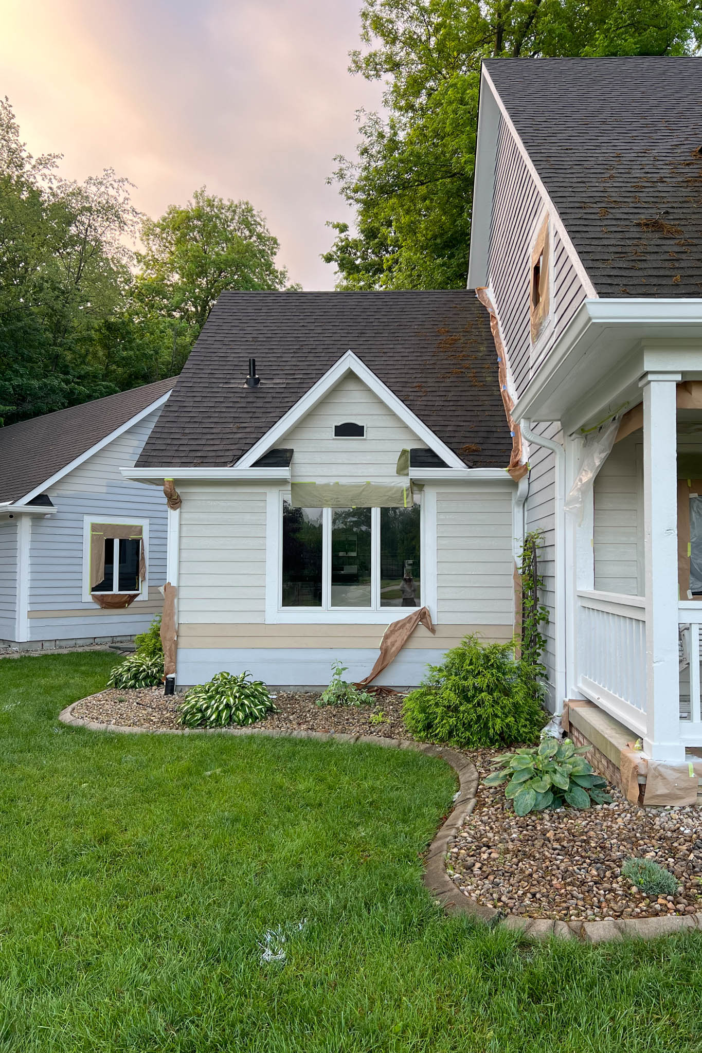 View of front of house with newly painted siding in the color beige.