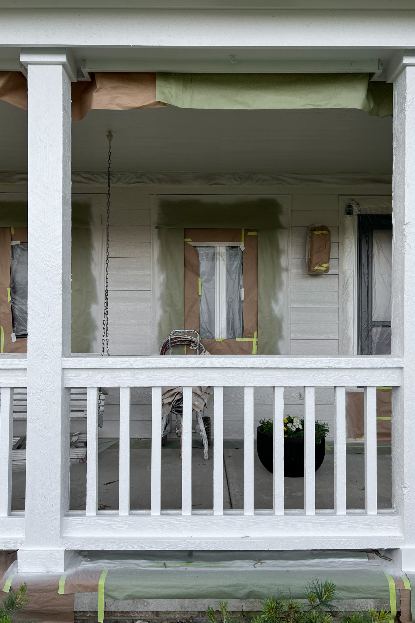 Front porch with newly painted white railing.