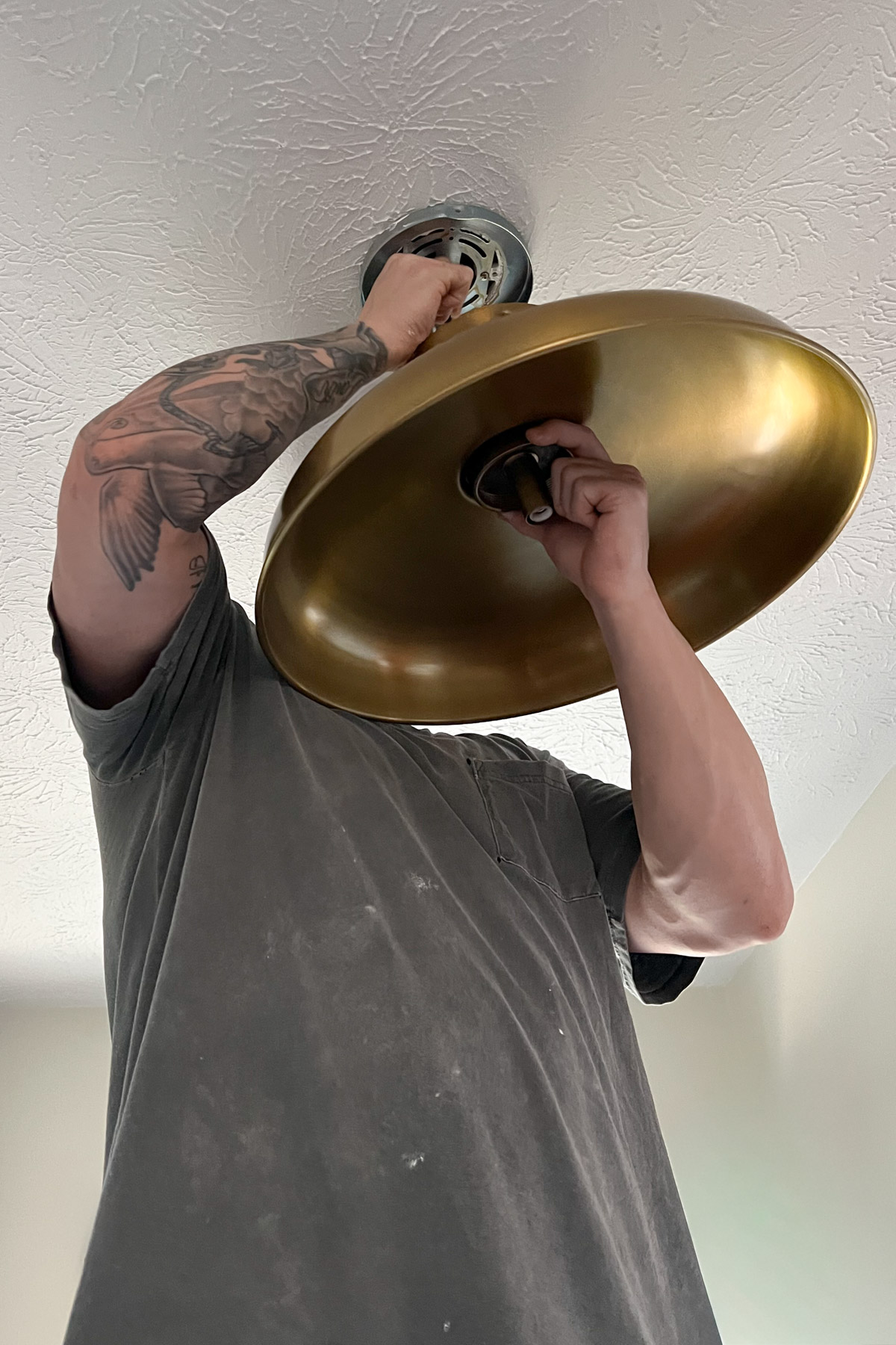We wanted an impactful entryway, so we swapped the rustic barn wood fixtures for sleek, solid brass flush mounts.