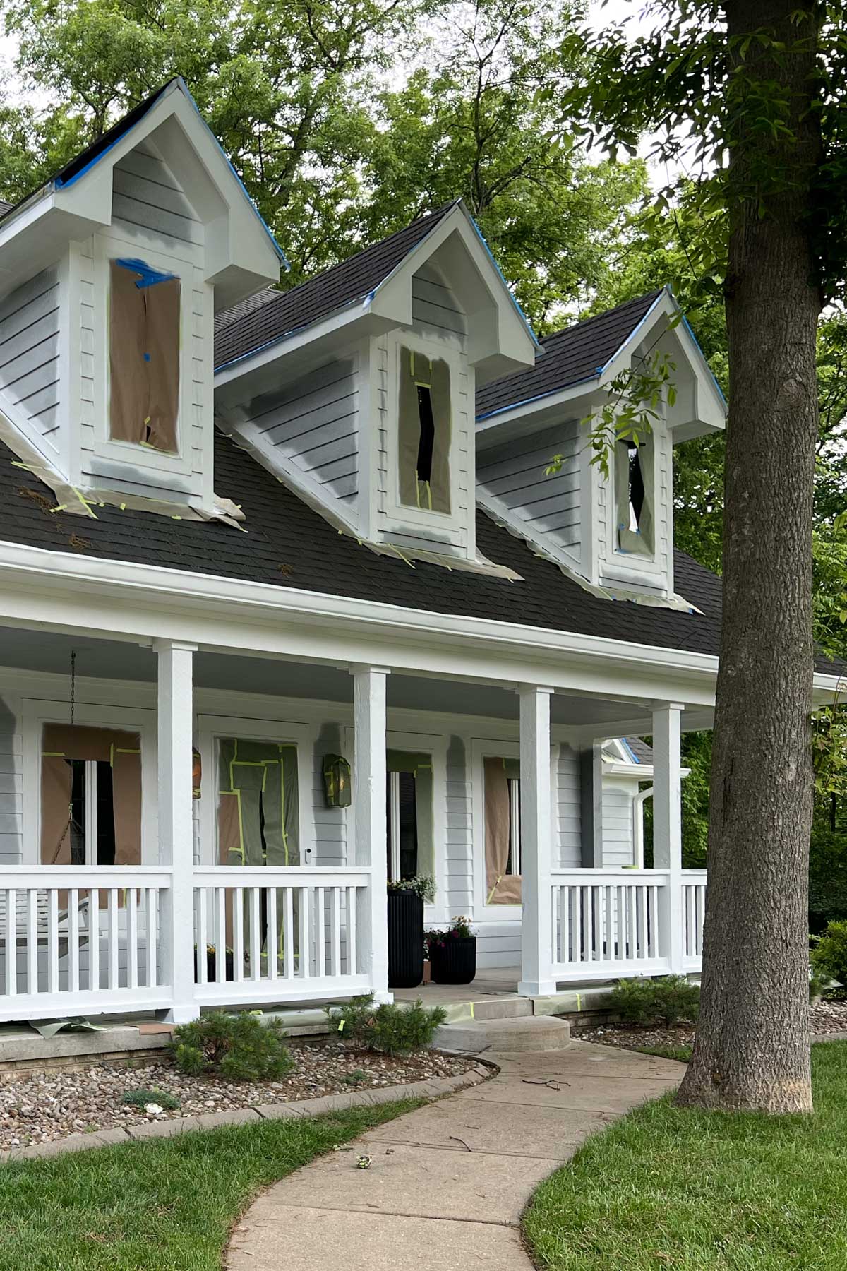 The white trim and front porch are finished, making a big difference and highlighting architectural details.
