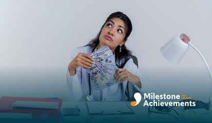 Female ABA therapist sitting at a desk holding a stack of money, pondering with a thoughtful expression.