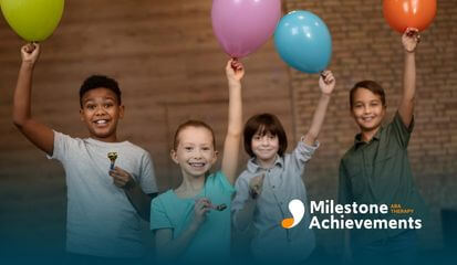 Group of smiling children holding colorful balloons and party horns, celebrating together in a bright indoor space.