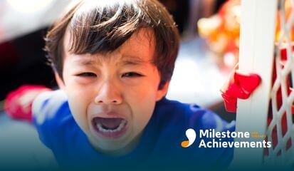 Young child crying loudly indoors, showing emotional distress often associated with sensory overload in autism setting