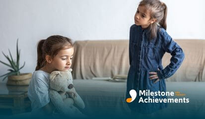 One child hugs a teddy bear while another stands nearby with hands on hips, showing tension and rigid thinking.