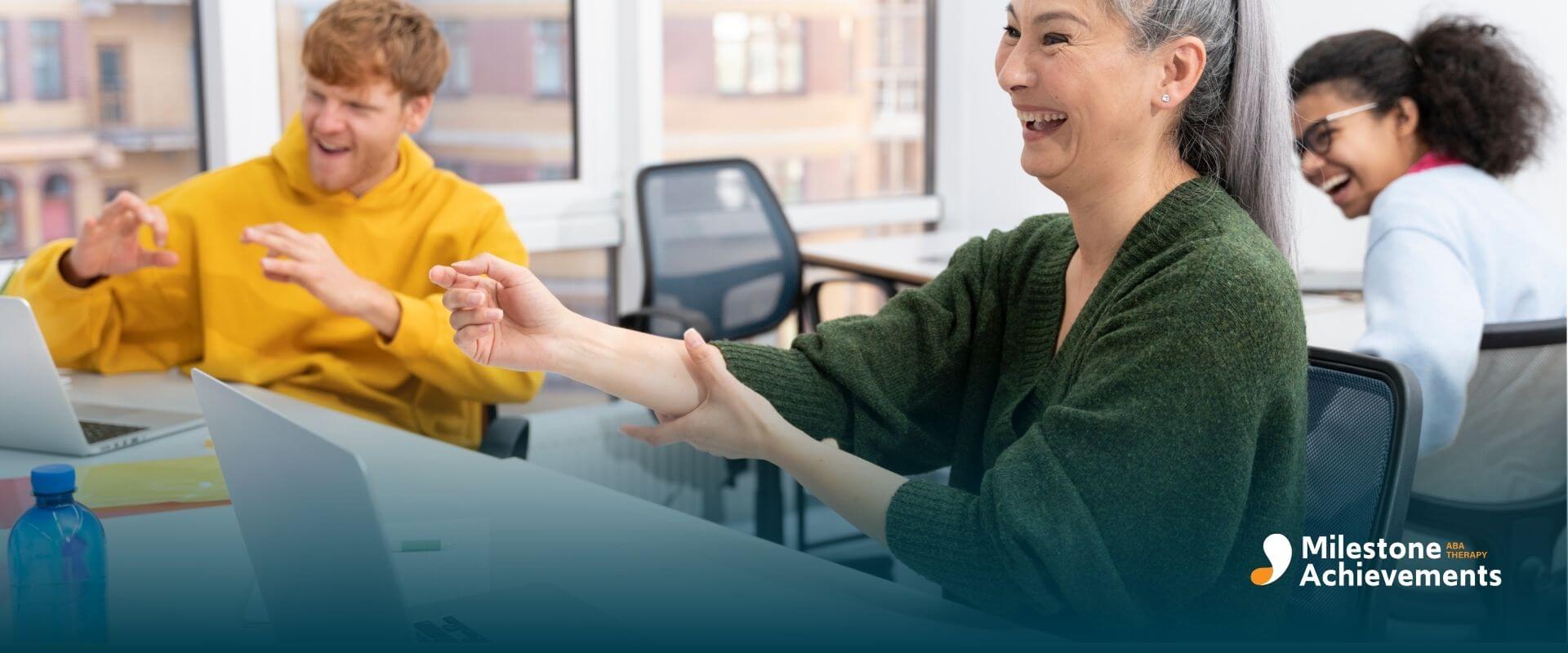 Thepists laughing and interacting during a group activity in an office setting, highlighting inclusive workplaces.