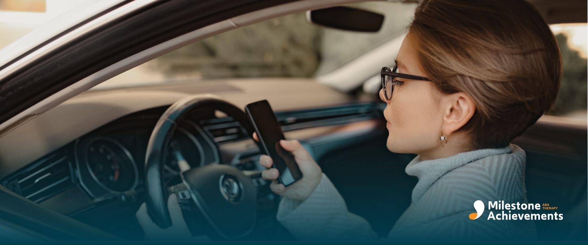 Autistic woman in car holding smartphone while driving, showing divided attention and possible sensory distraction.