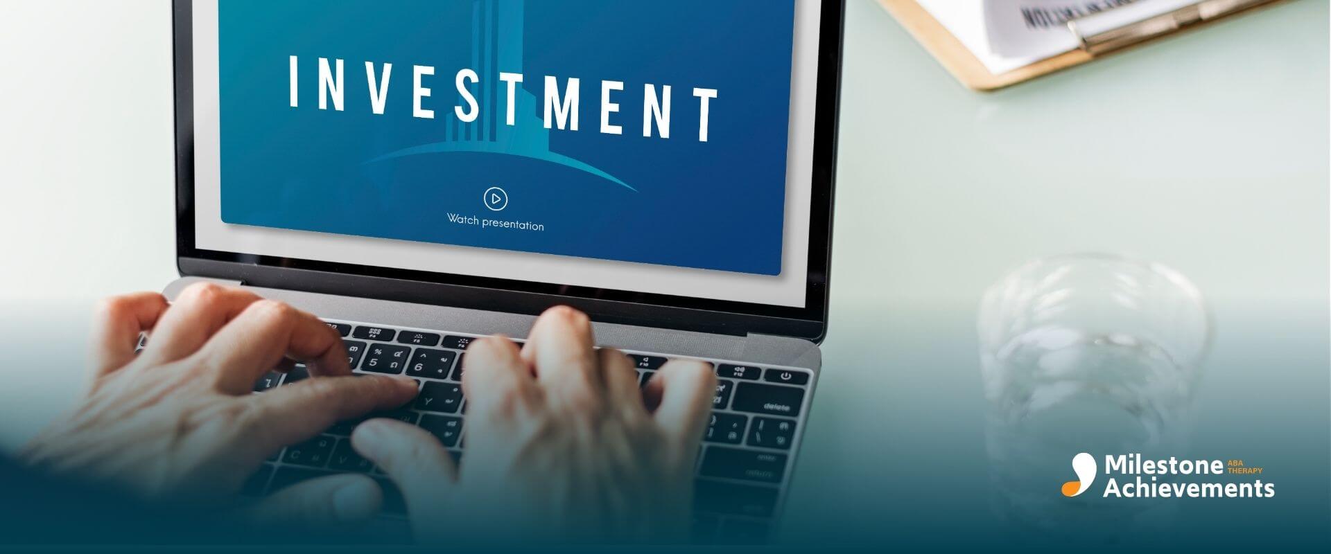 A therapist typing on laptop displaying investment presentation screen, representing career growth and certification value.