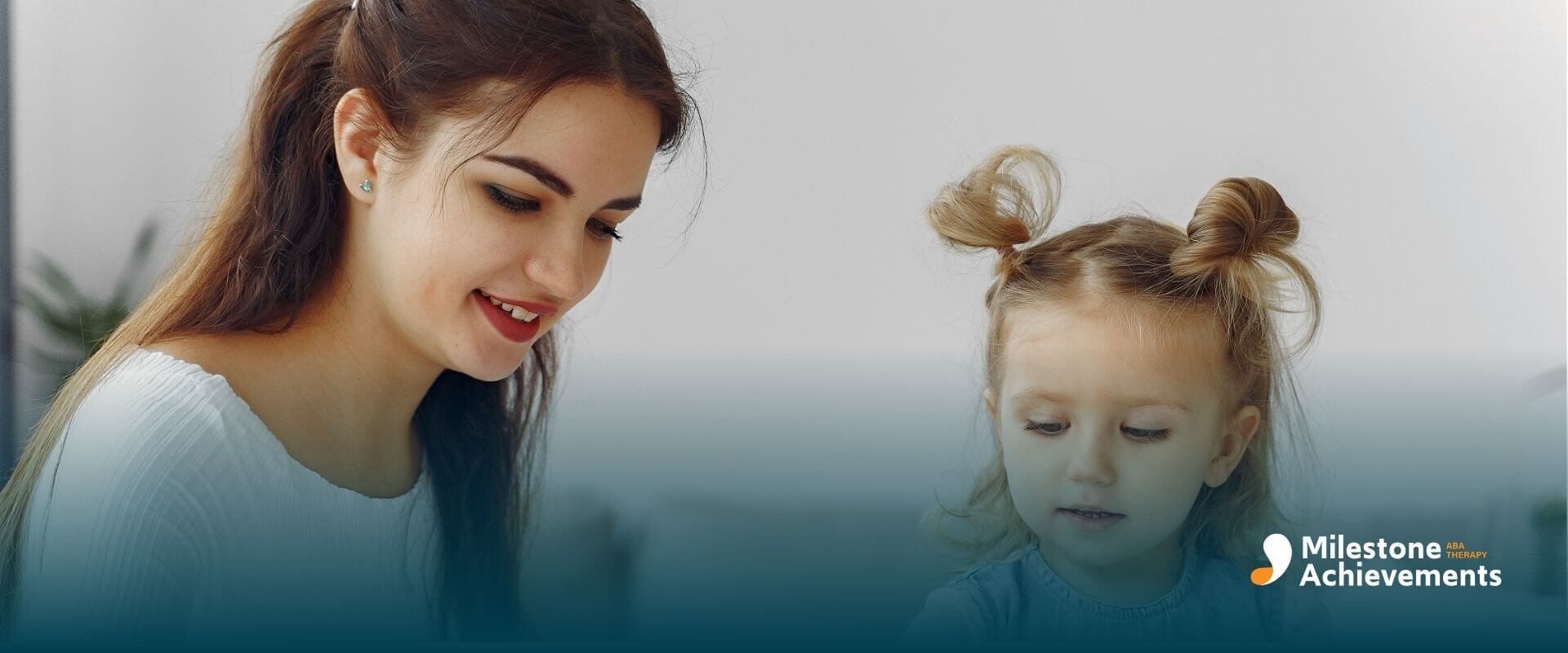 Therapist guiding autistic baby while playing with a colorful shape puzzle to support early learning and development skills.