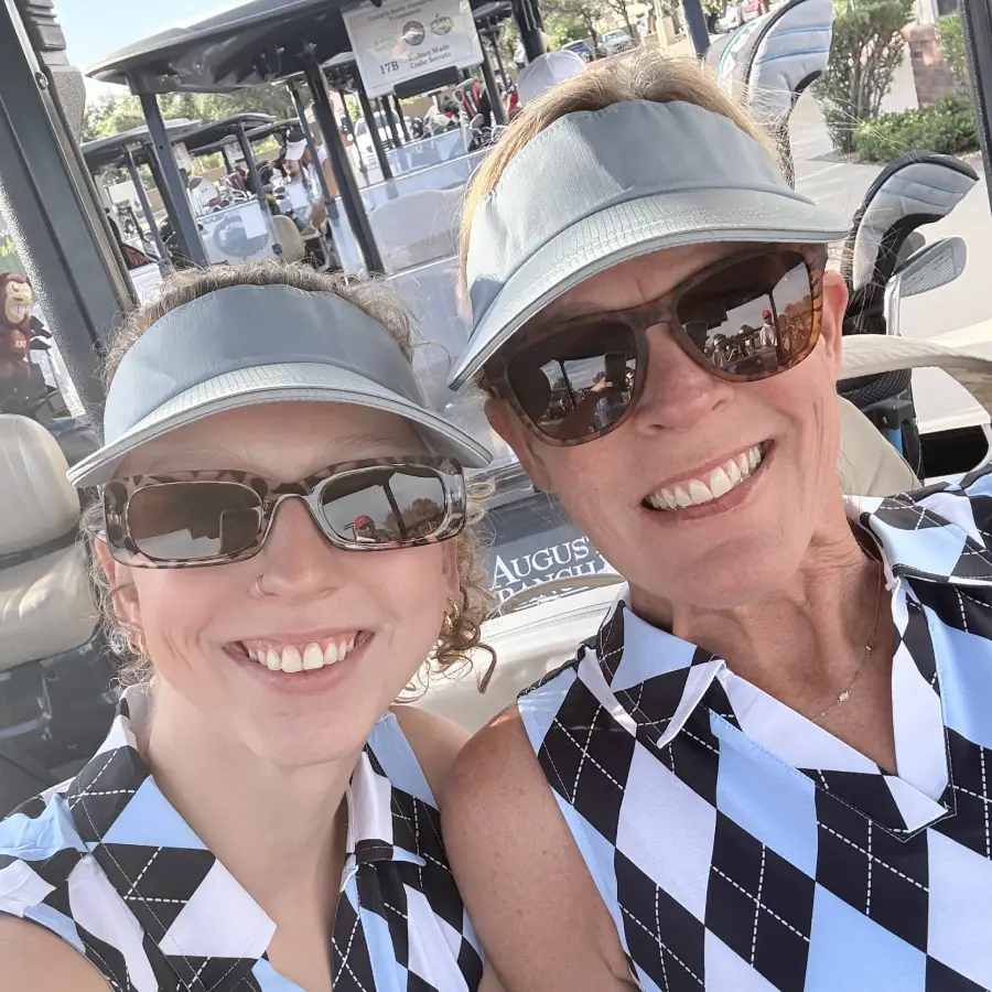 Two Crossfit Incite women in a golf cart