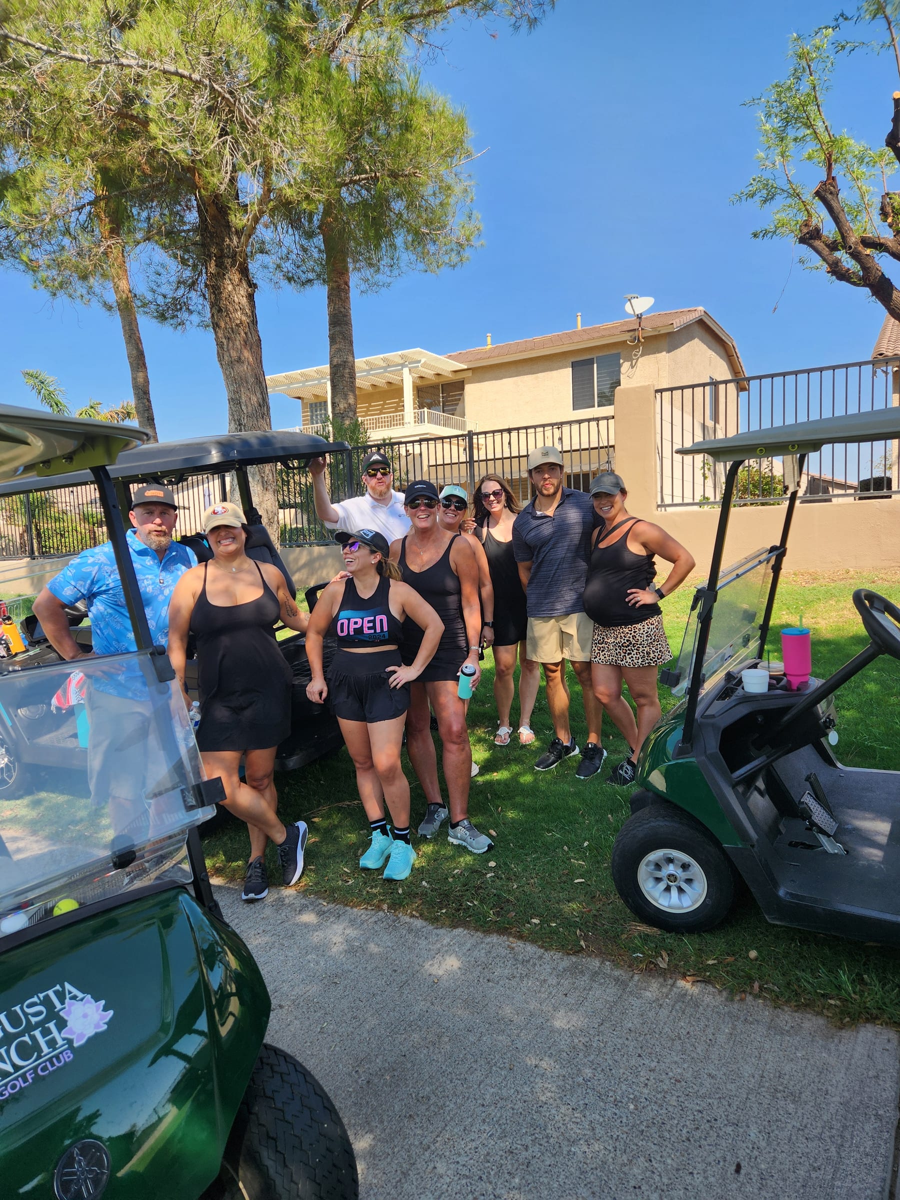 CrossFit Incite members posing next to golf carts at the 2025 golf tournament