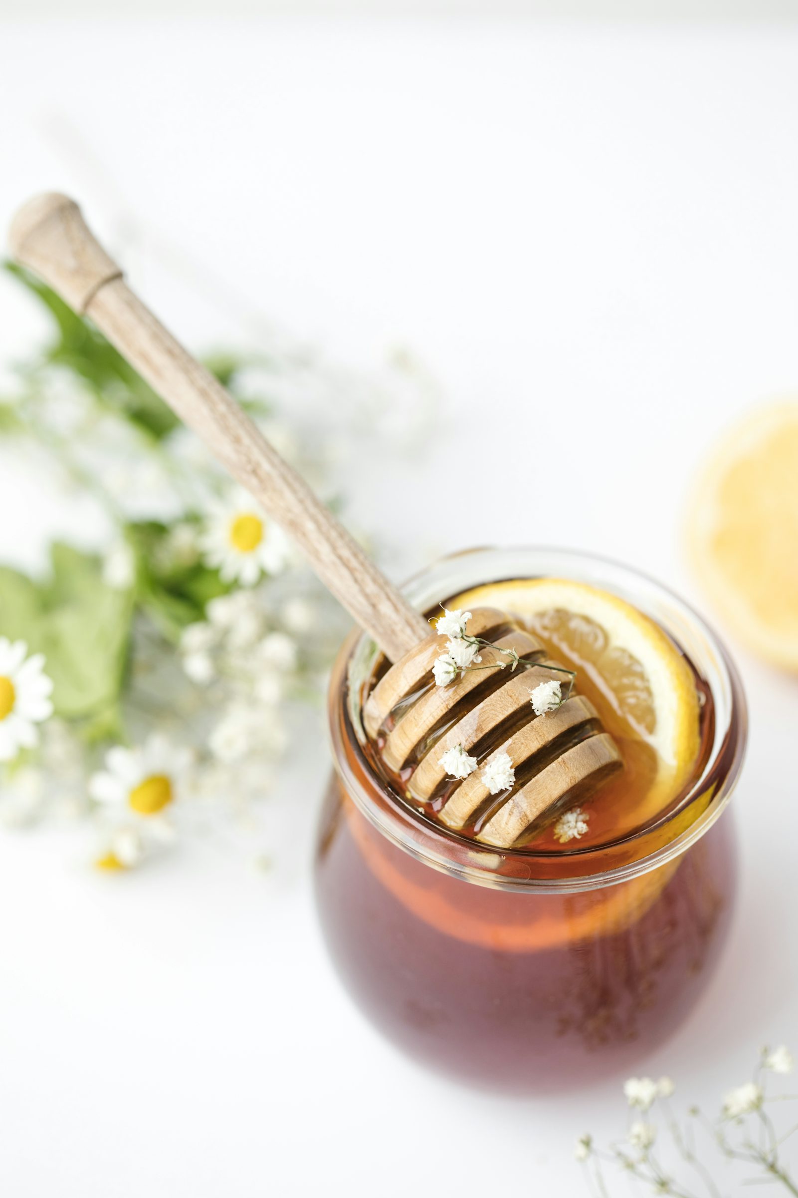 A glass of honey on a table — a morning remedy for a sore throat