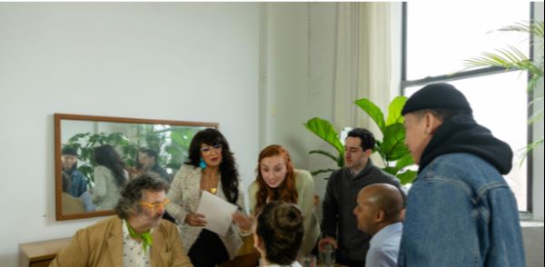 Group of people around a table in the middle of a discussion