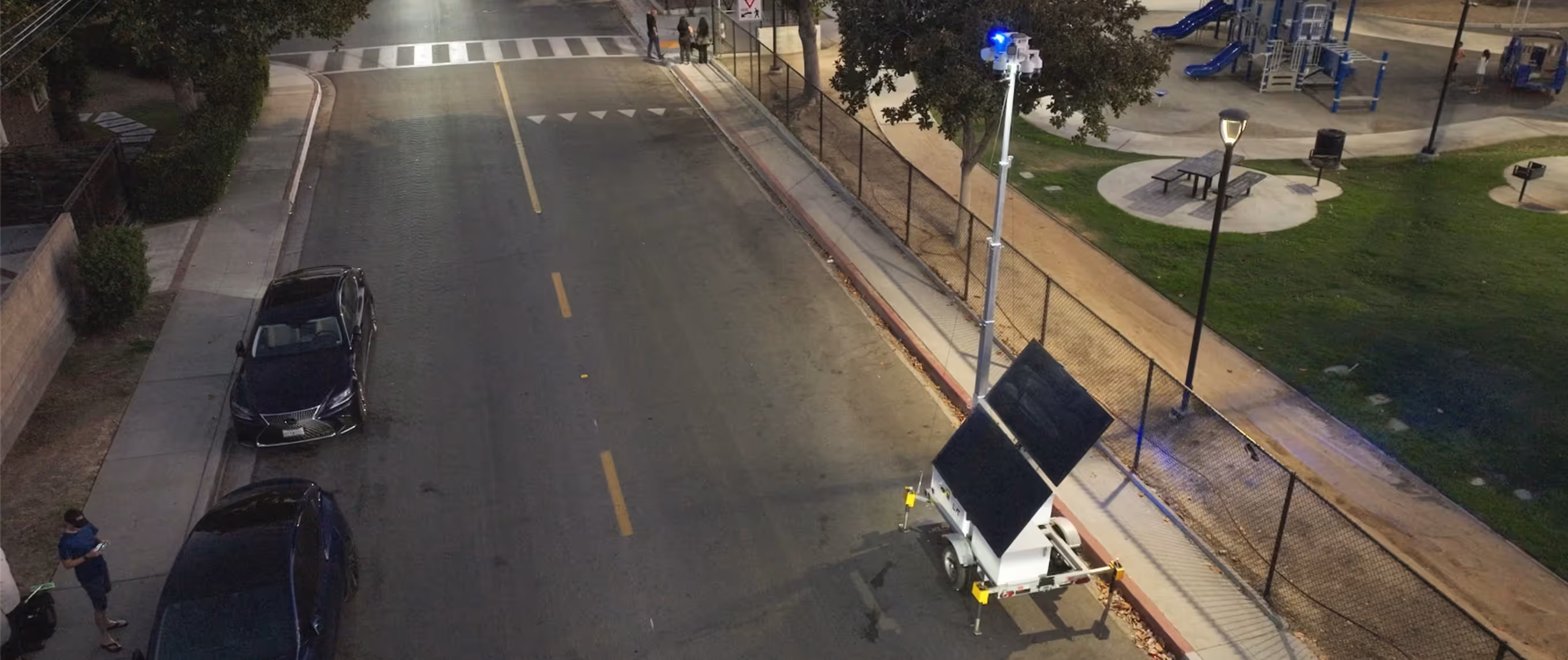 LVT mobile solar security tower deployed on a plaza next to train tracks and a station.
