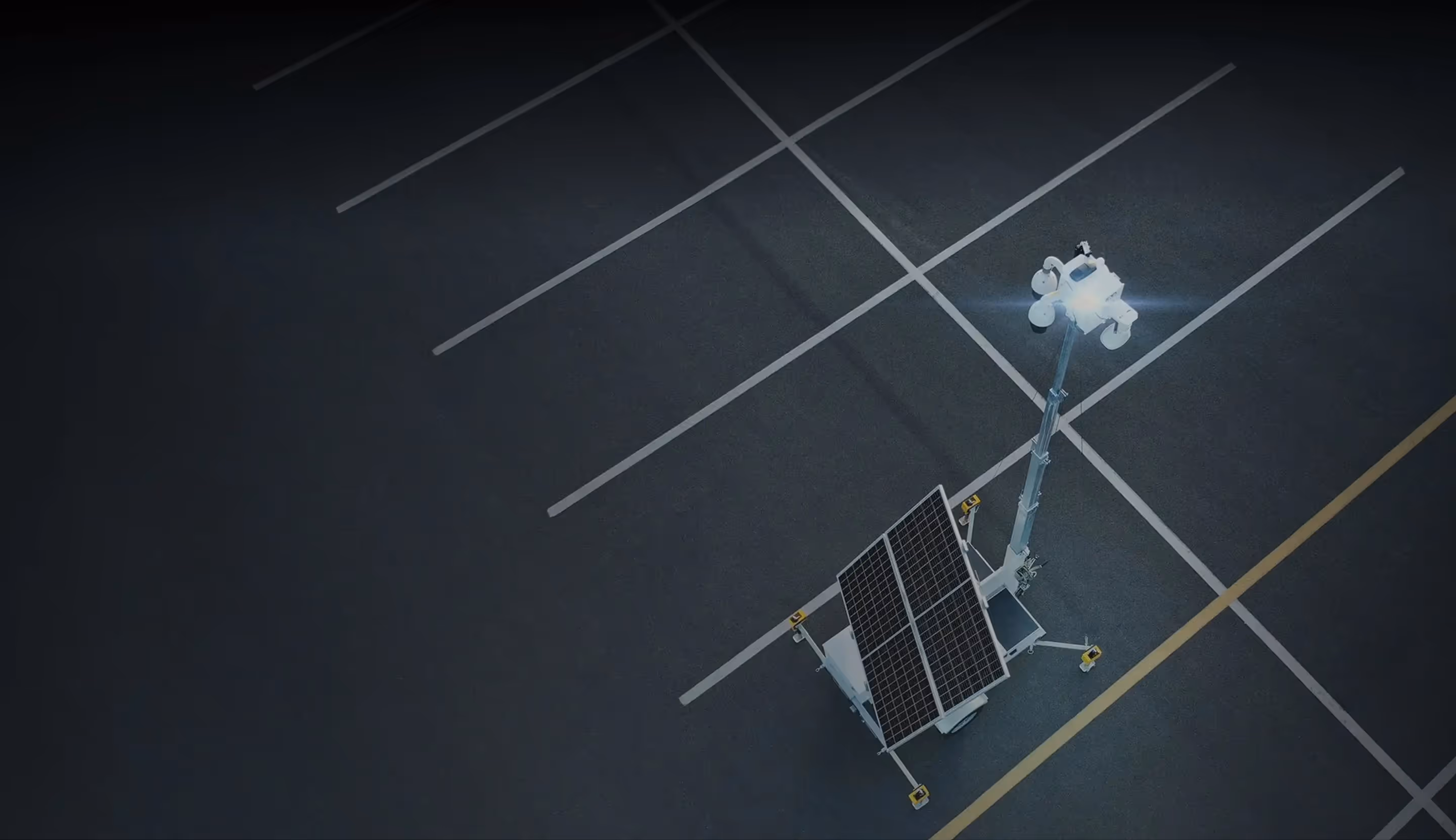 Aerial view of an LVT mobile security unit with an illuminated light in an empty parking lot.