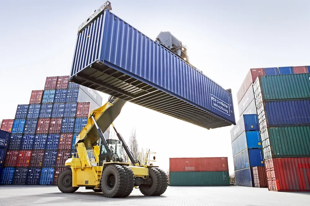 crane-lifting-shipping-container-on-construction-site
